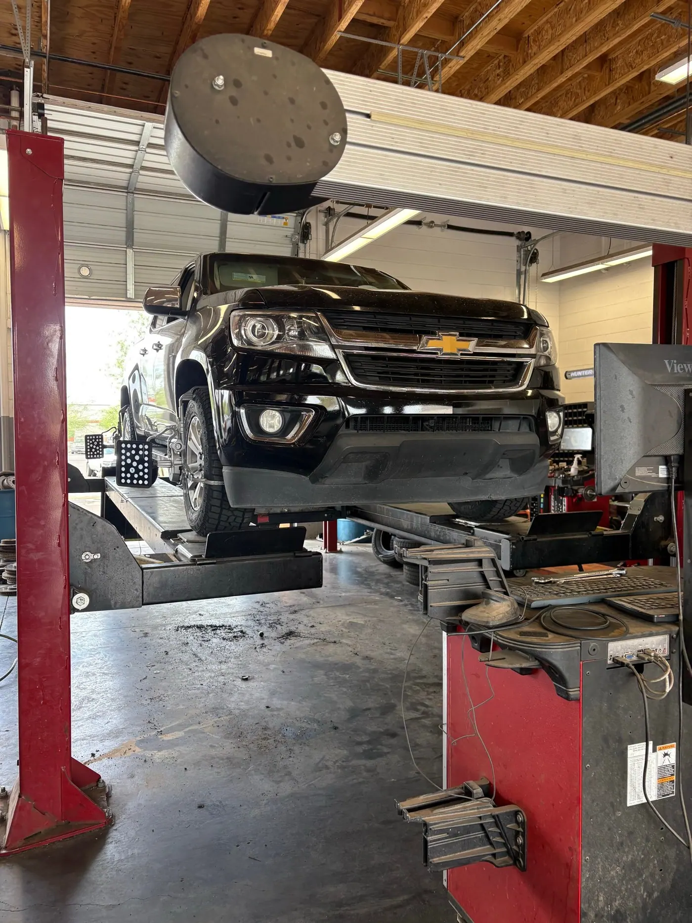 Chevy Silverado on a shop lift, full diagnostics