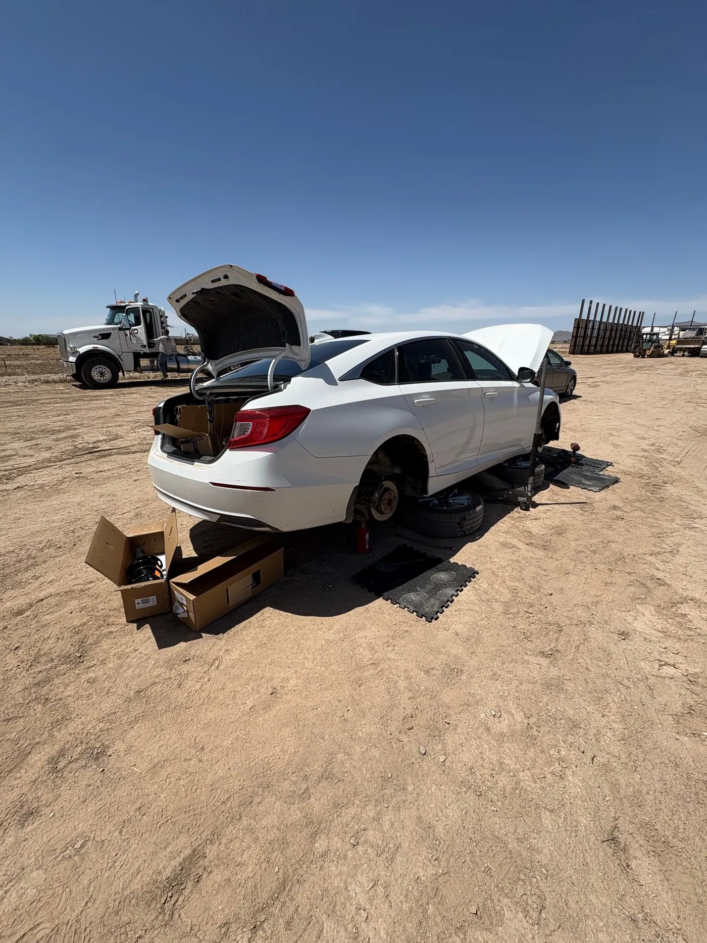 Honda sedan on-site service with the service truck in the background